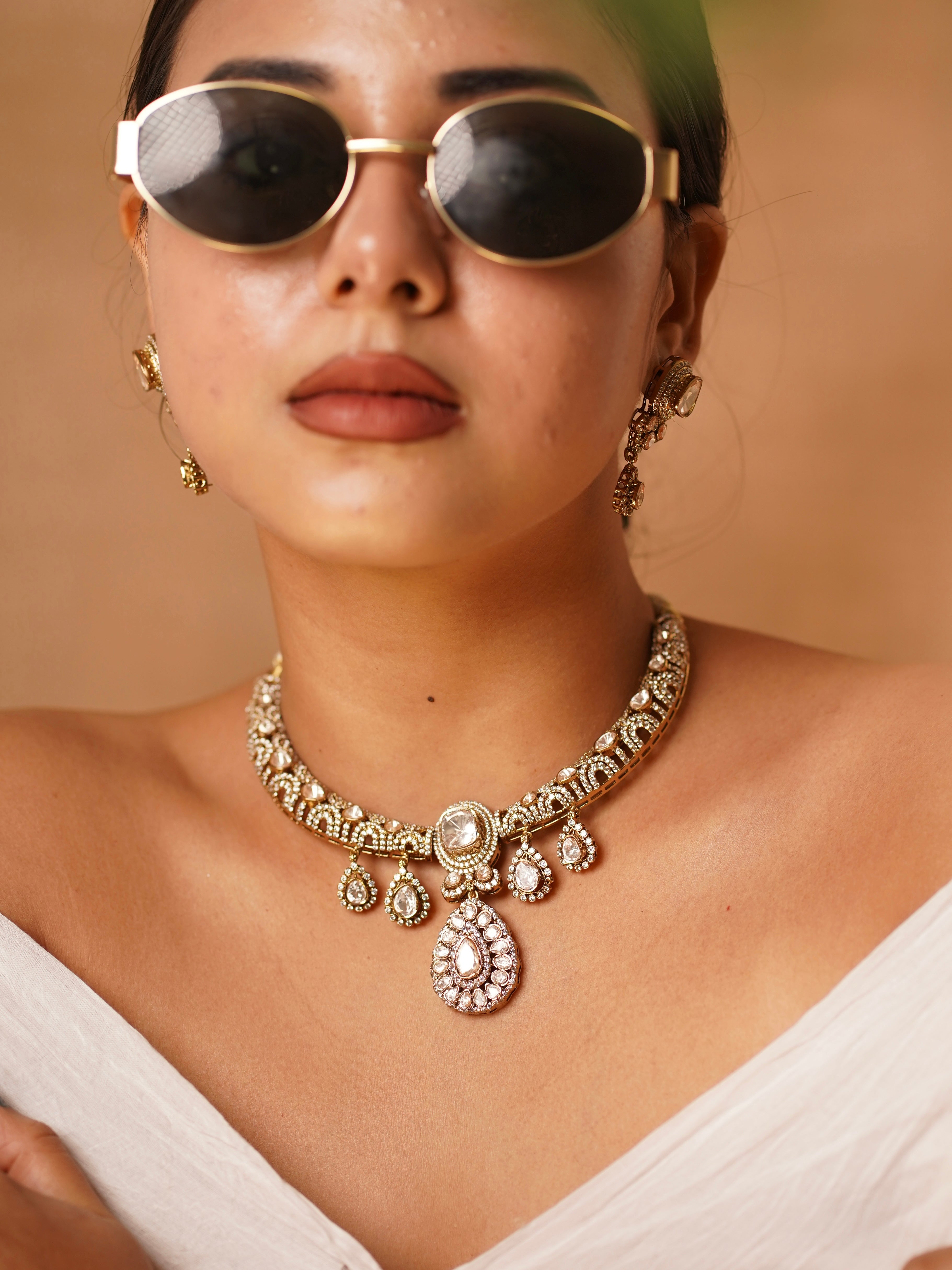 Hasli-style necklace set with polki stones, teardrop danglers and a high-polish gold finish